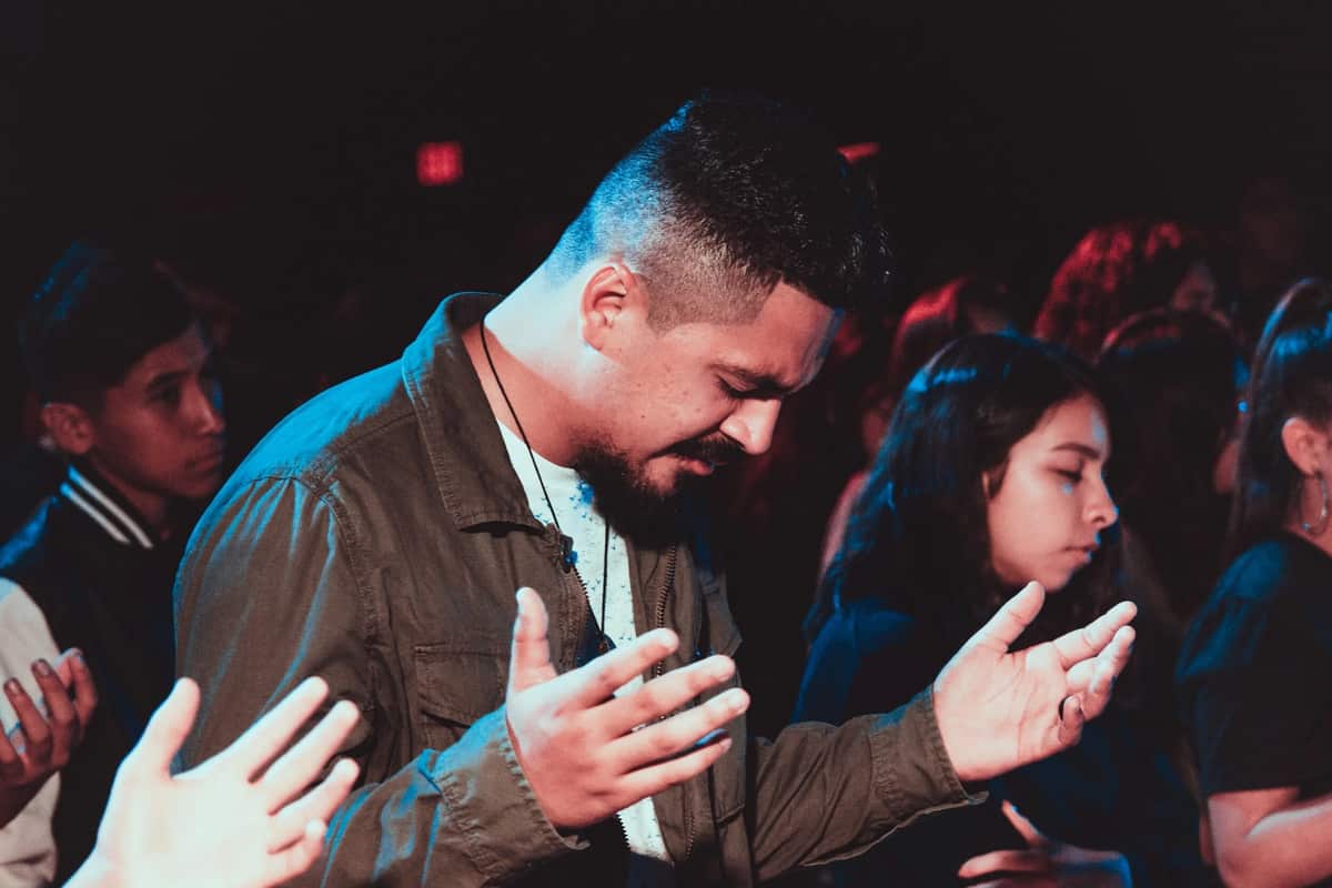 A man praying with open hands during a church worship service